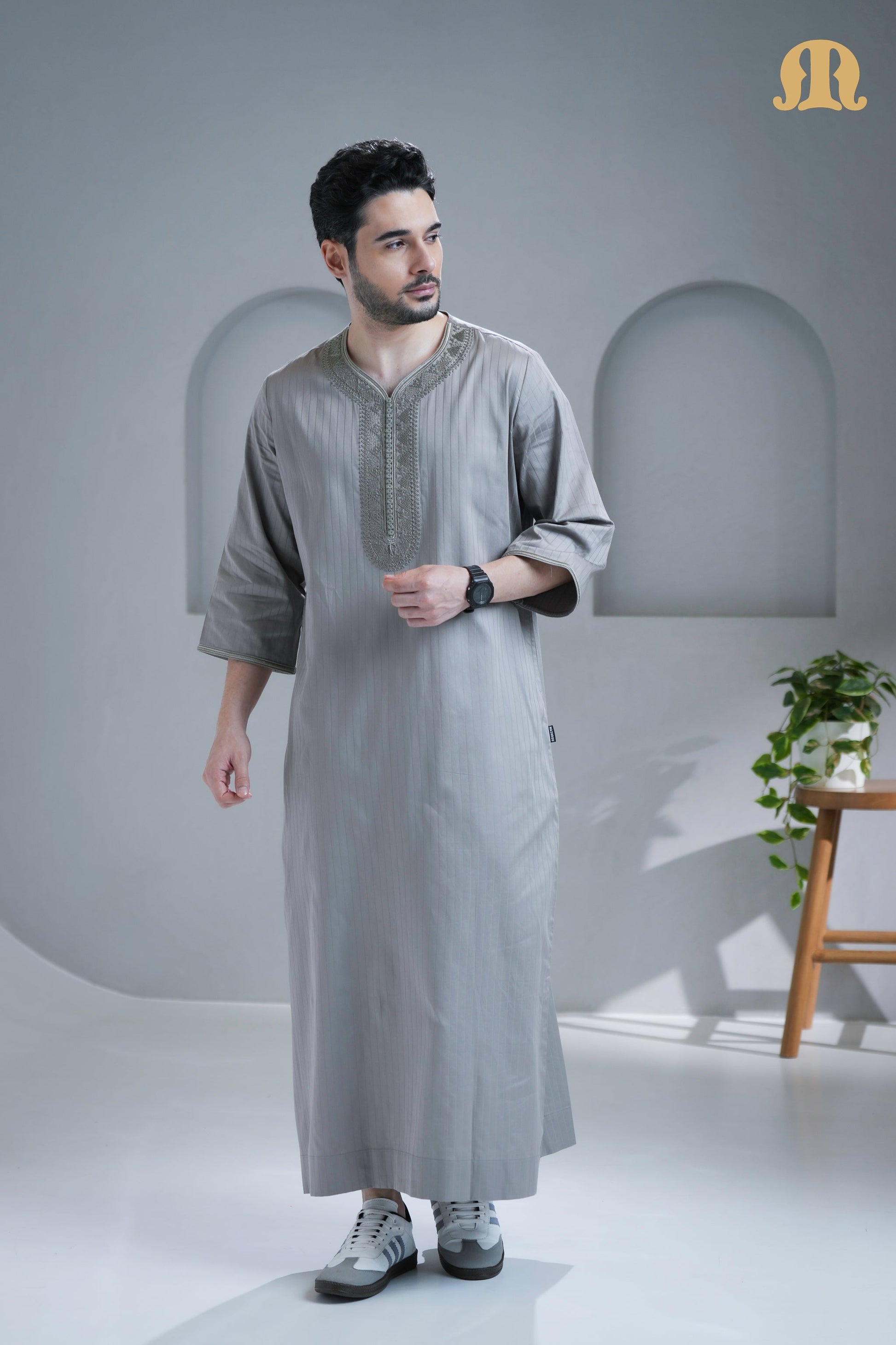 Close-up of the intricate detailing on the neckline of the grey Zagora Thobe.