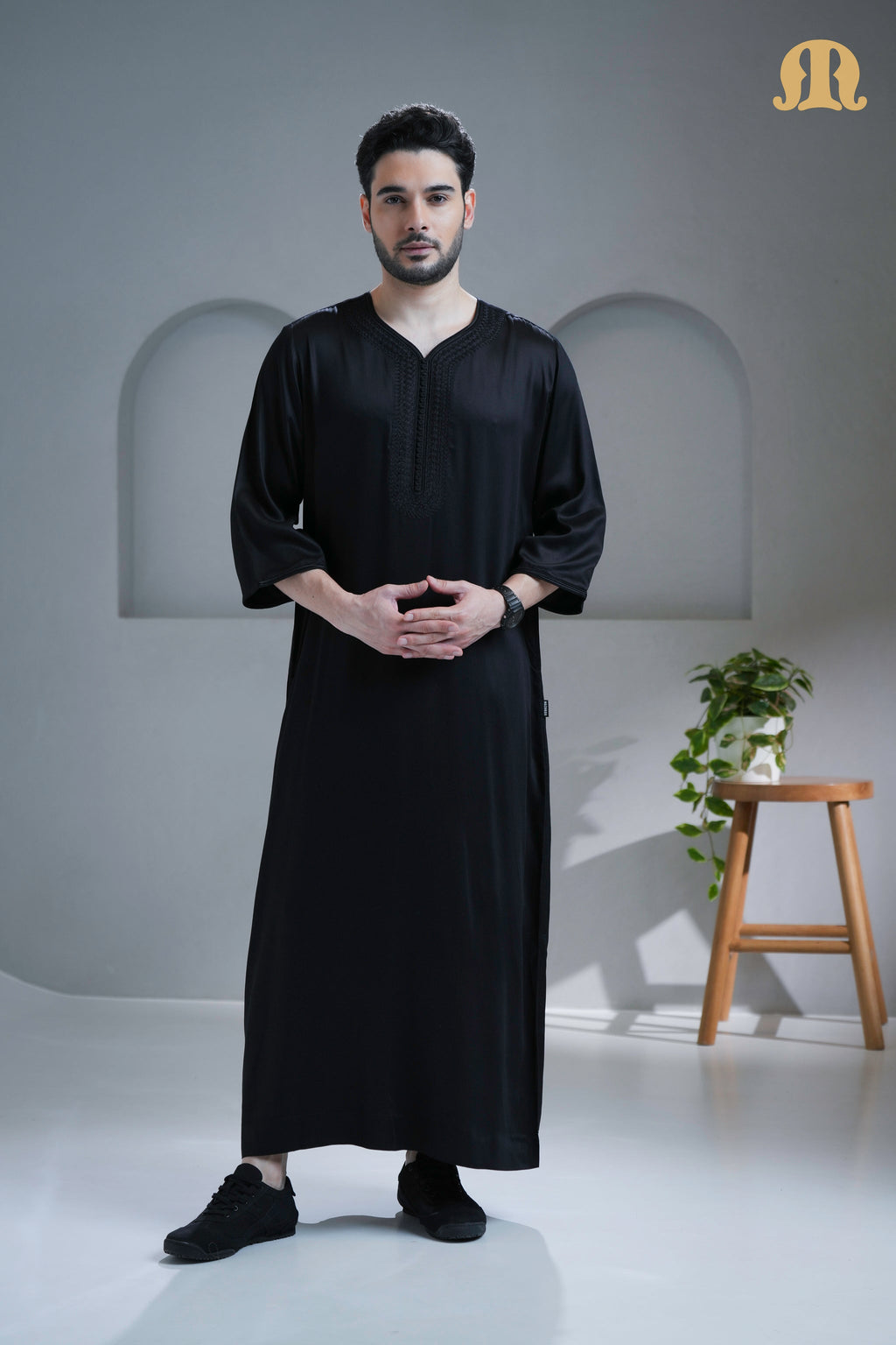 Man wearing the sophisticated Tiznit Black Moroccan Thobe from HayaStyle.
