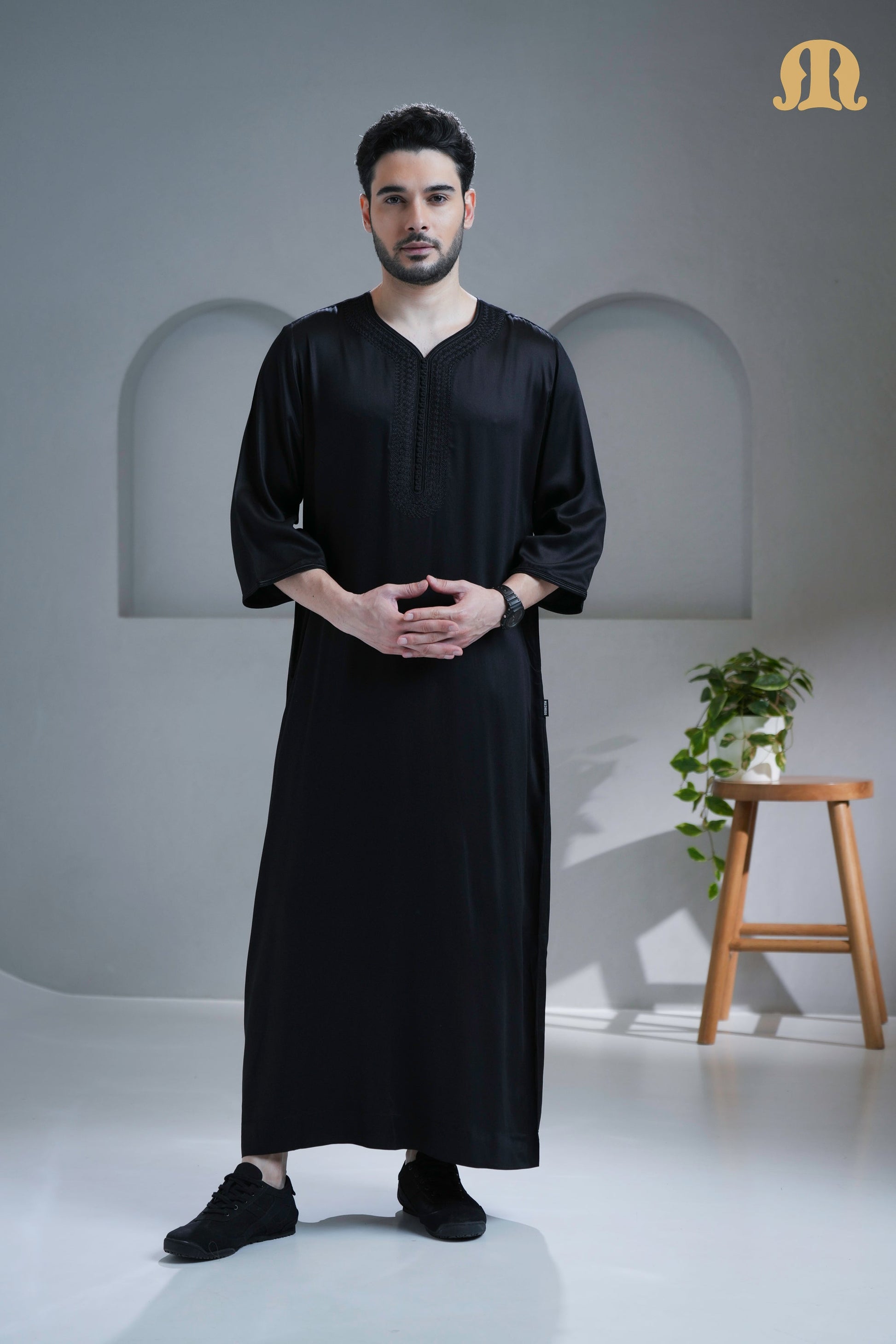 Man wearing the sophisticated Tiznit Black Moroccan Thobe from HayaStyle.
