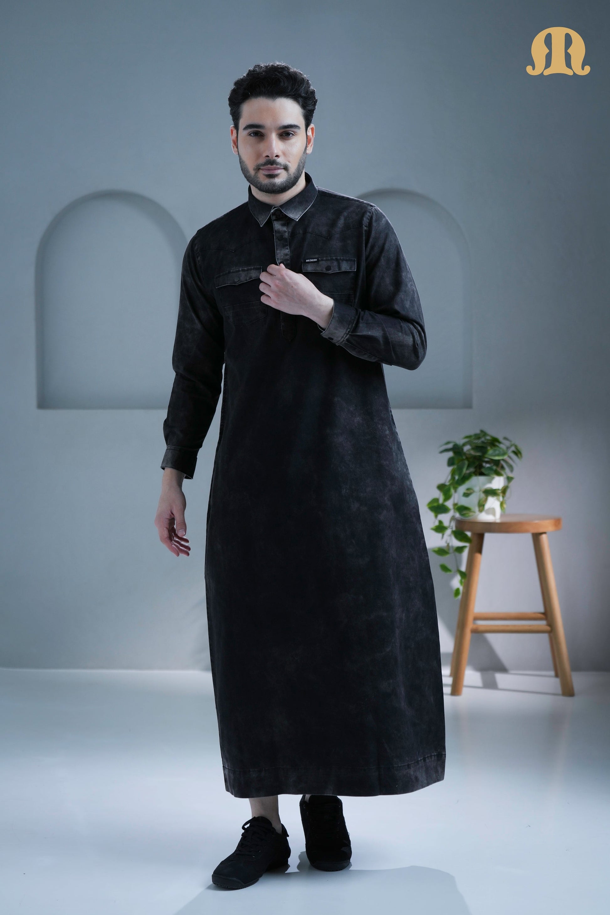 Man showcasing the edgy style of the Brimstone Black Denim Thobe.
