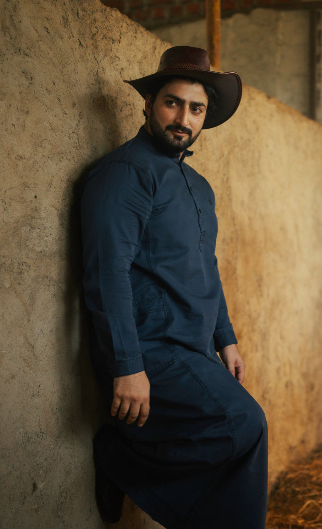 Man wearing the stylish Mekong Navy Blue Denim Thobe, available from HayaStyle.
