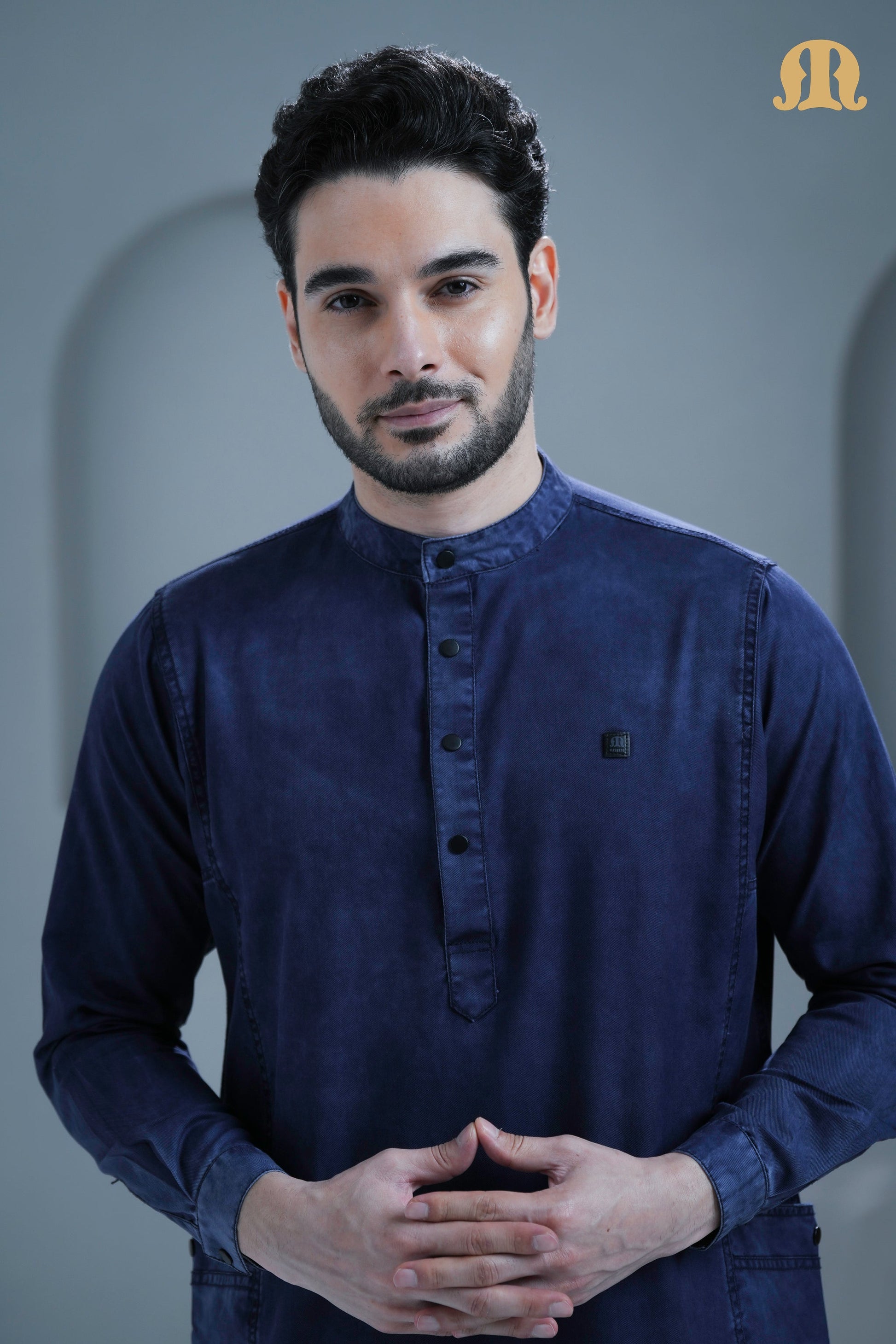 Detailed view of the stitching on the placket of the Mashroo navy denim thobe.
