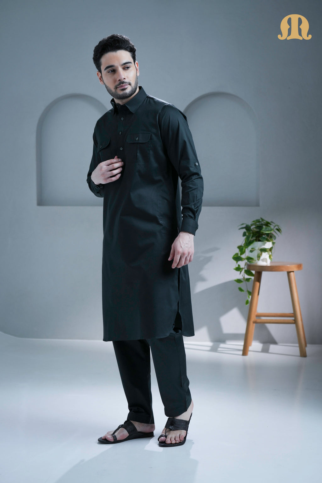 Detail of the front pockets and cuffed sleeves on the Mashroo Pathani suit.
