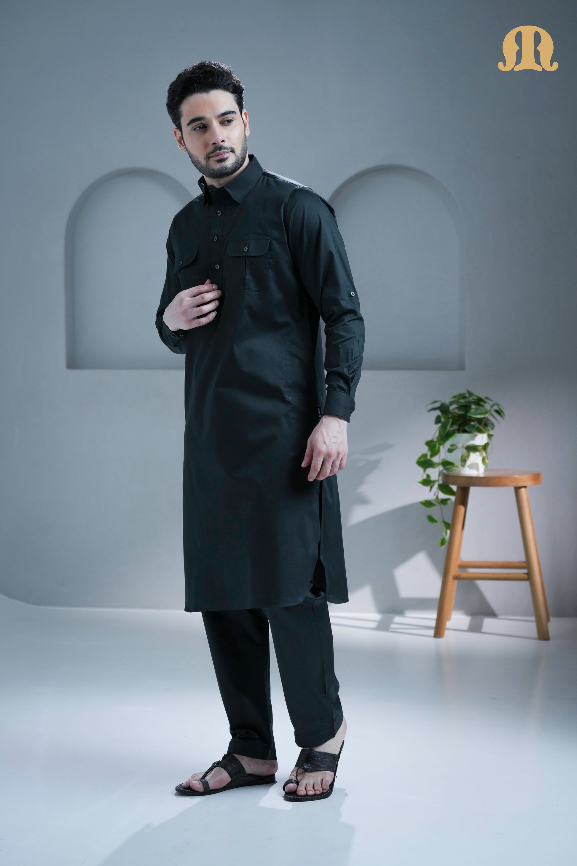 Detail of the front pockets and cuffed sleeves on the Mashroo Pathani suit.
