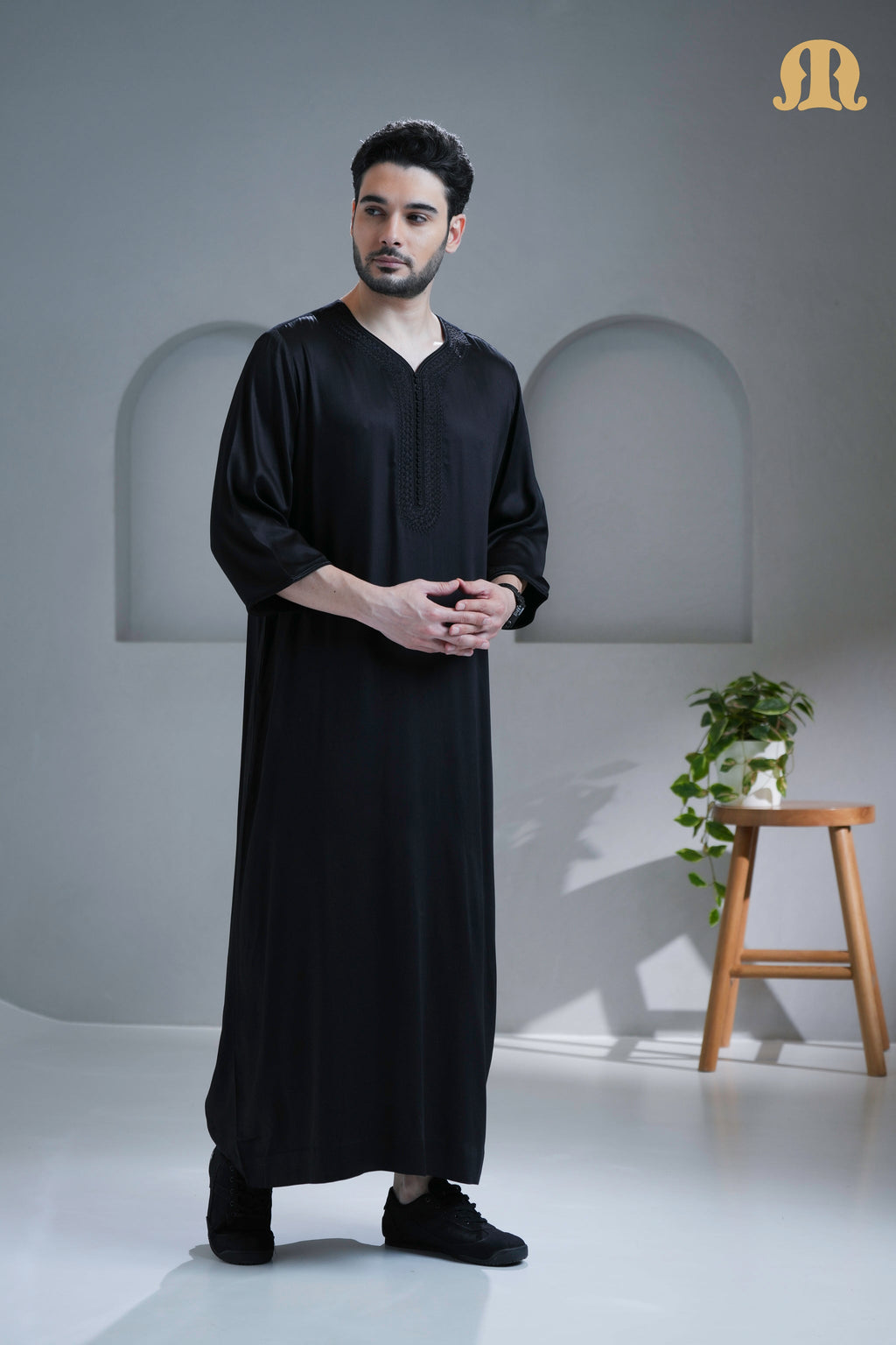 Side profile of the Tiznit Thobe showing the elegant drape of the black viscose.
