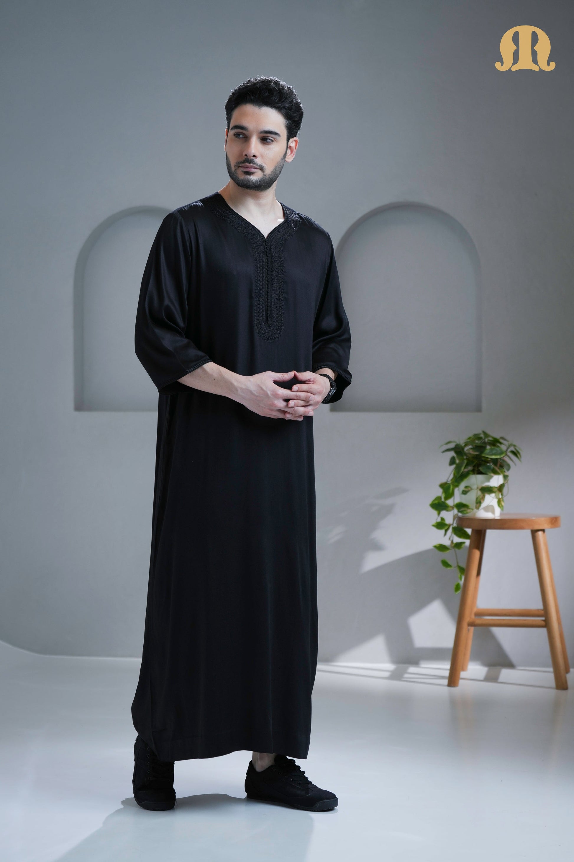 Side profile of the Tiznit Thobe showing the elegant drape of the black viscose.
