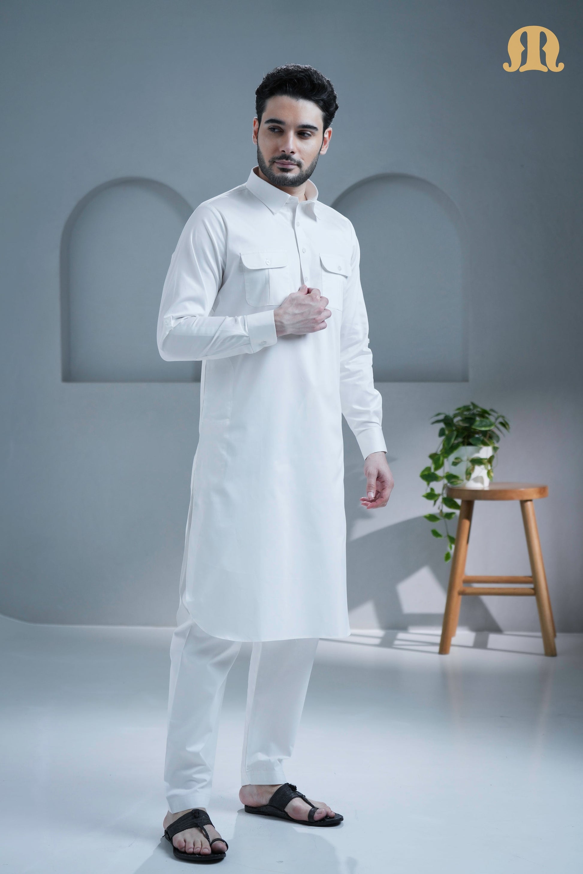 Close-up of the breathable cotton fabric on the white Pathani kurta.
