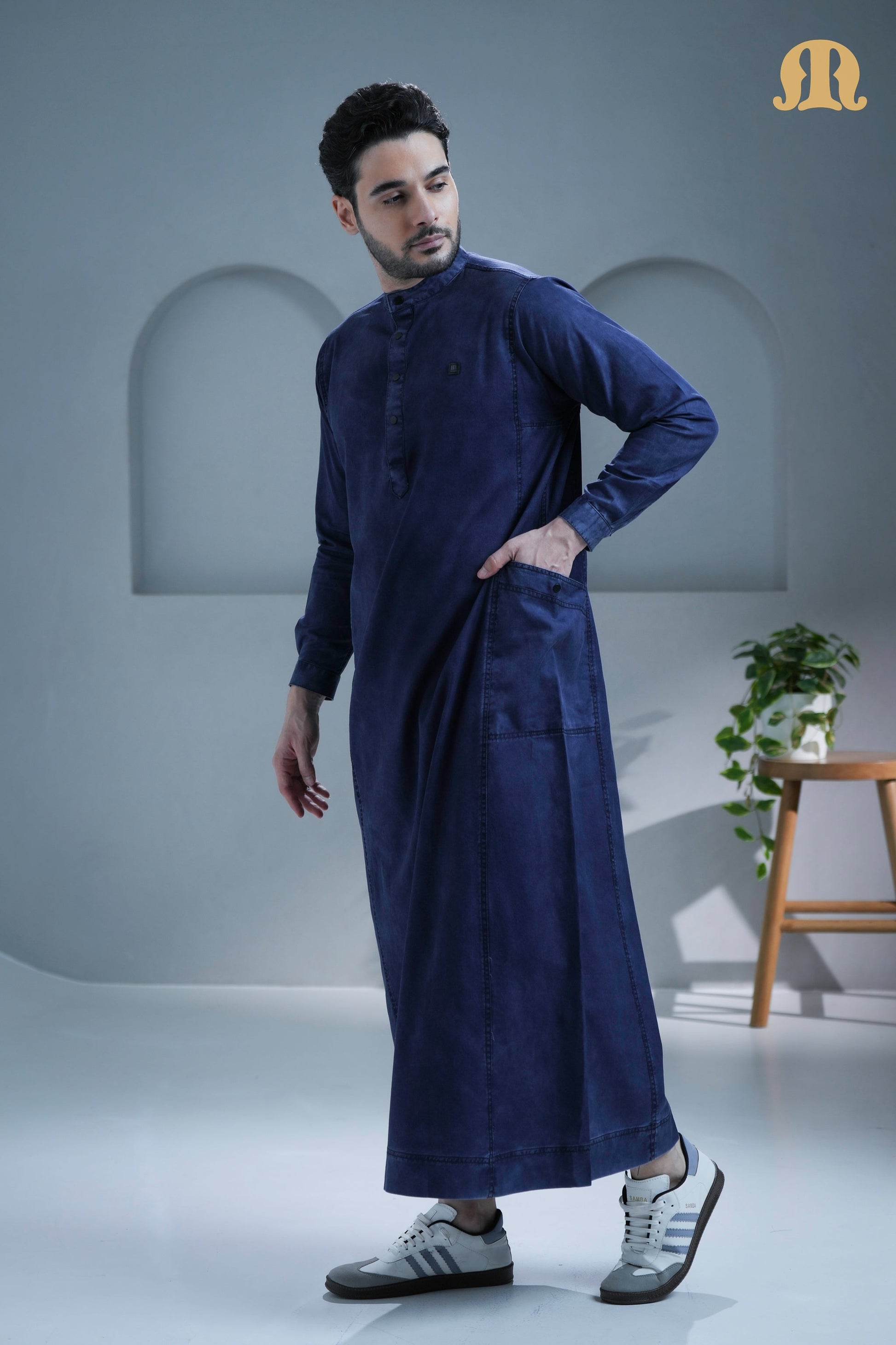 Side profile of the men's navy denim thobe from Mashroo.
