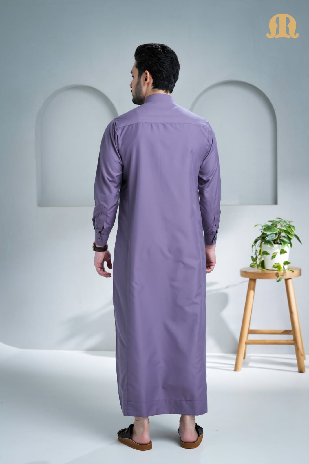 Side profile of the men's Unicus Thobe in a vibrant purple poly-cotton fabric.
