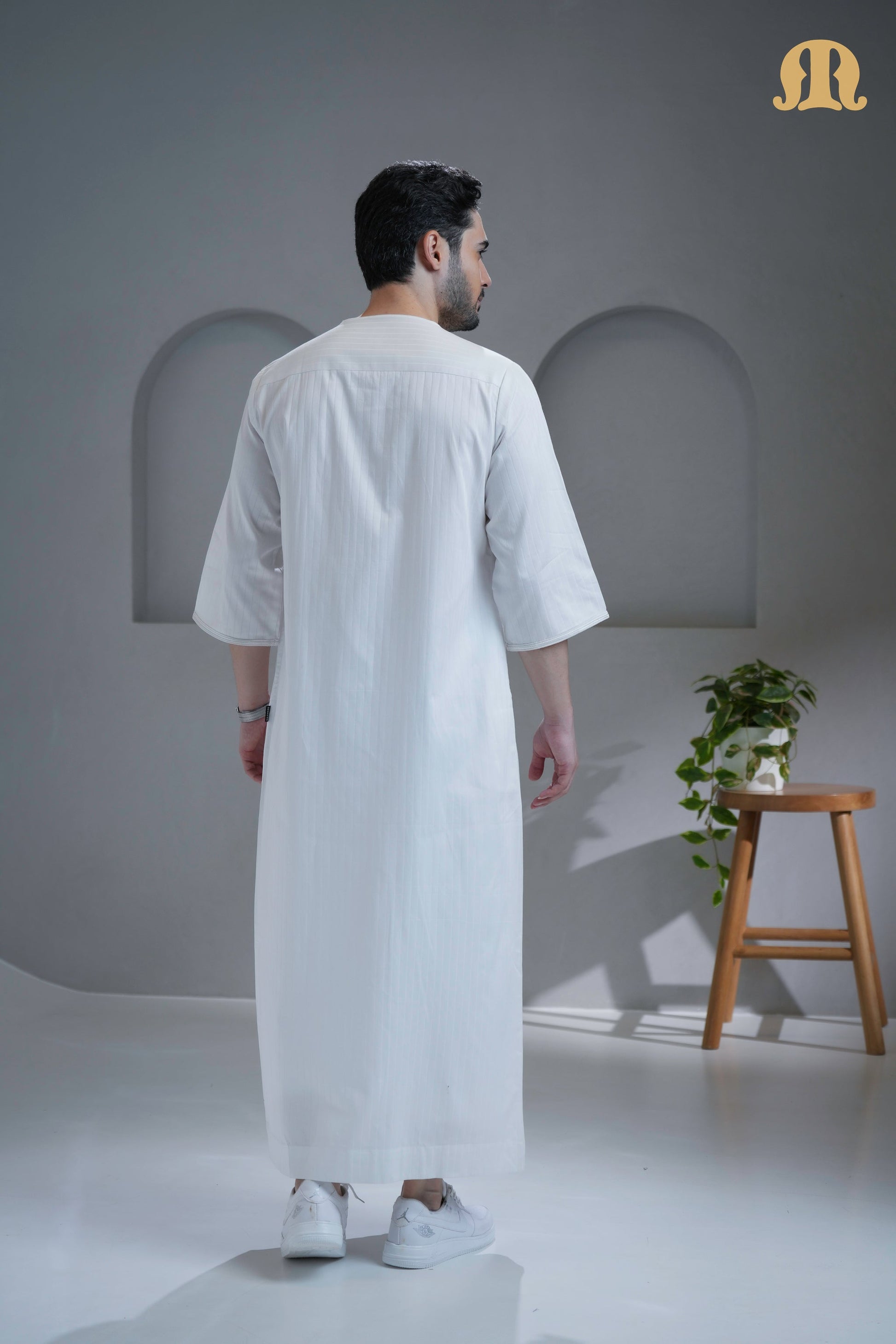 Man wearing the elegant Khatibi White Moroccan Thobe from HayaStyle India.
